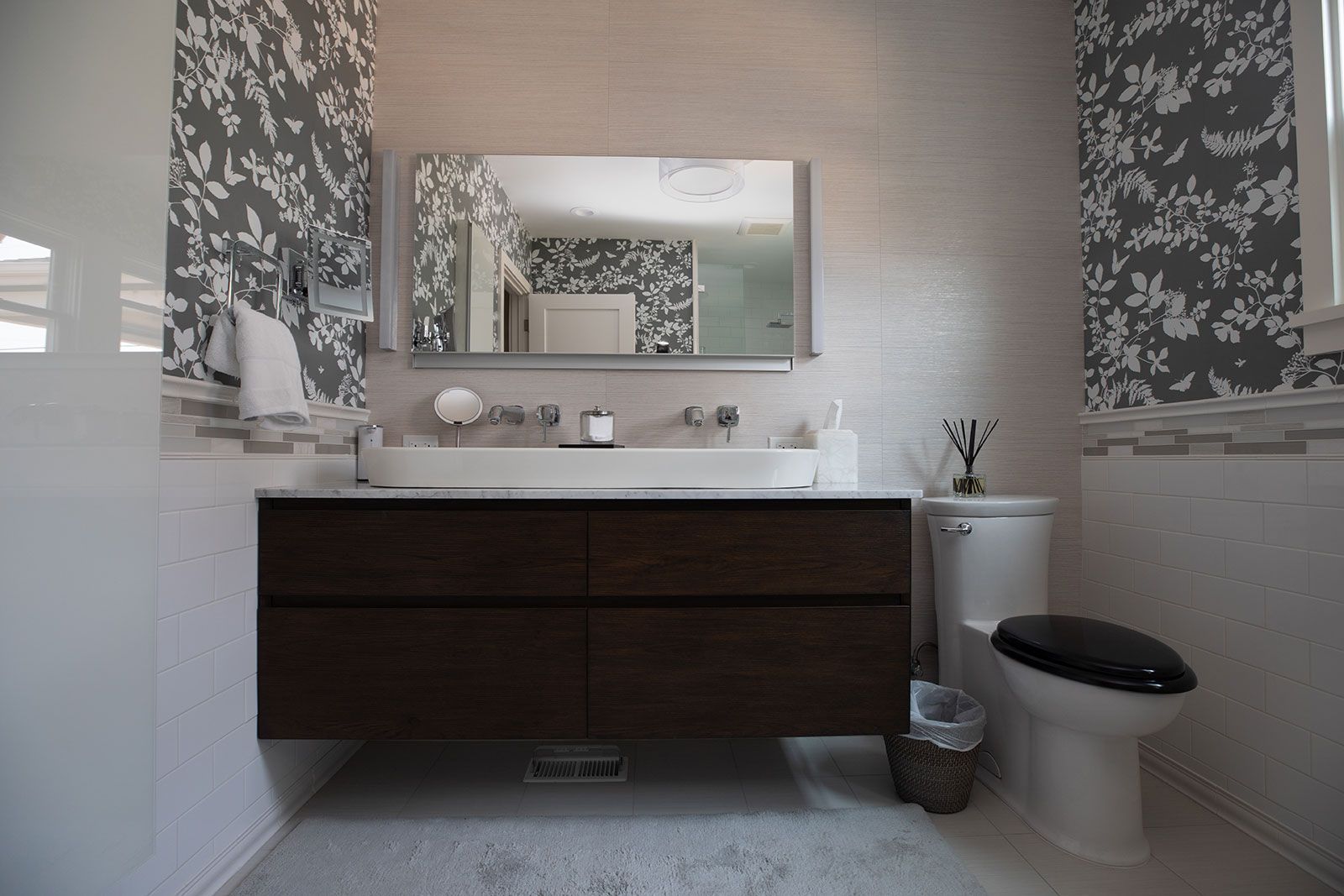 A bathroom with a toilet a sink and a mirror