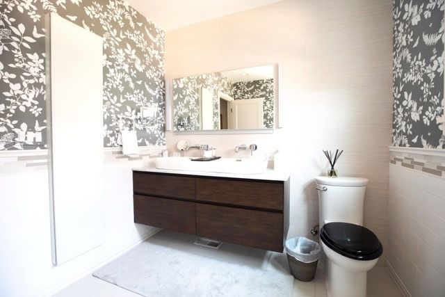 A bathroom with a toilet a sink and a mirror