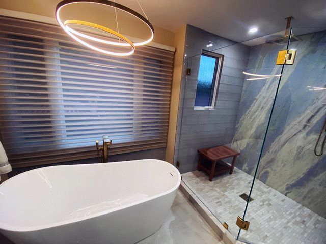 A bathroom with a bathtub and a walk in shower.