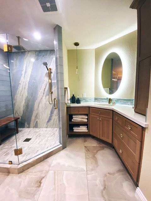 A bathroom with a walk in shower and a mirror