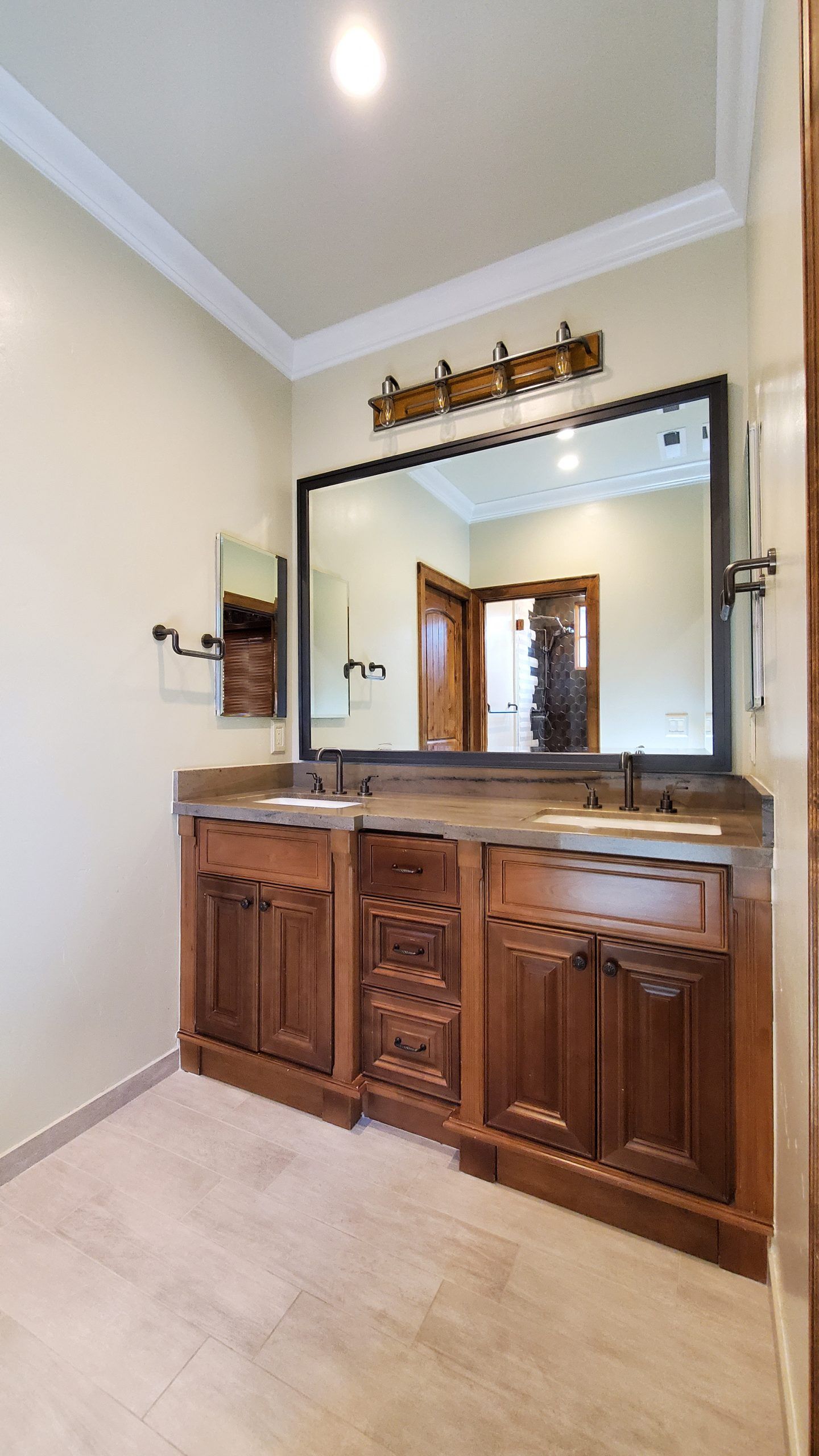 A bathroom with two sinks and a large mirror.