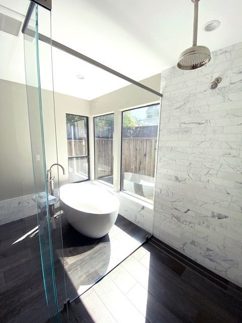 A bathroom with a tub and a walk in shower