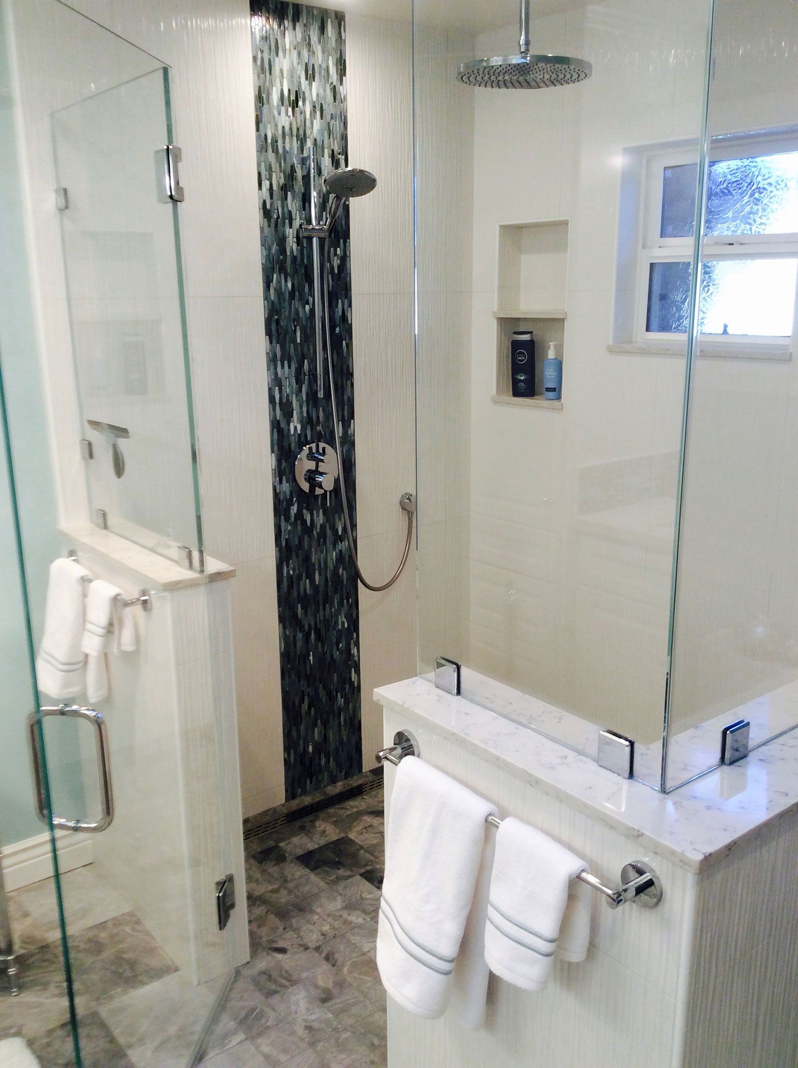 A bathroom with a shower , tub , and mirror.