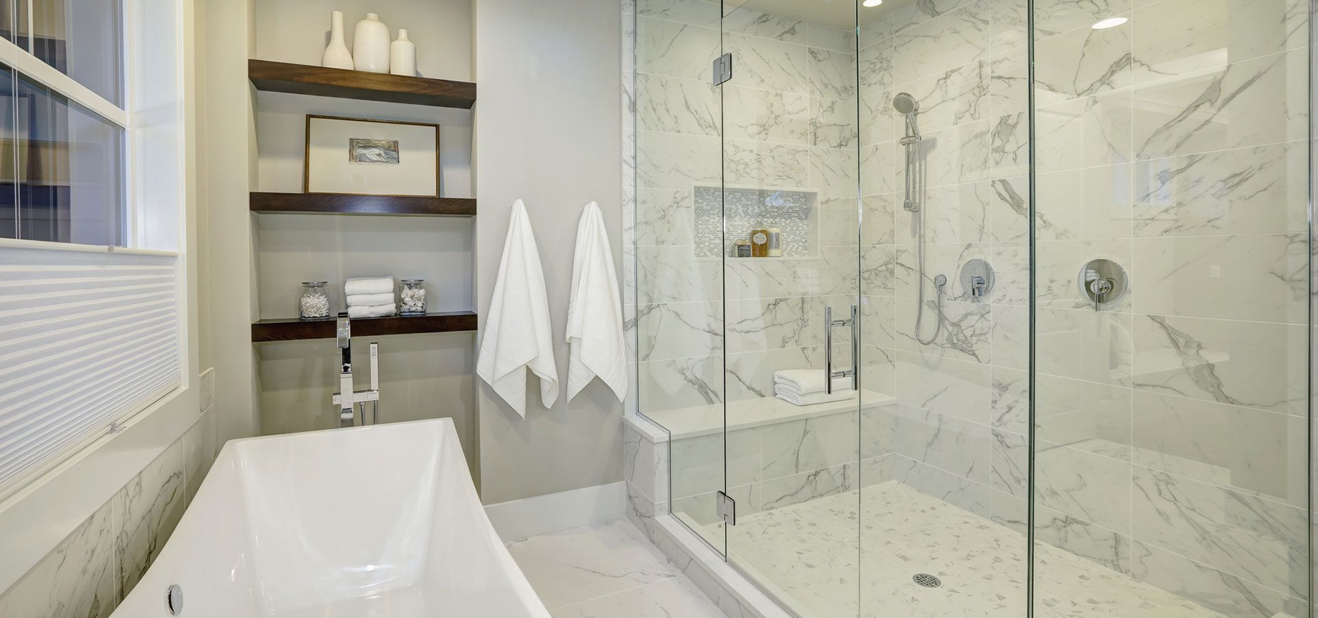 A bathroom with a bathtub and a walk in shower.