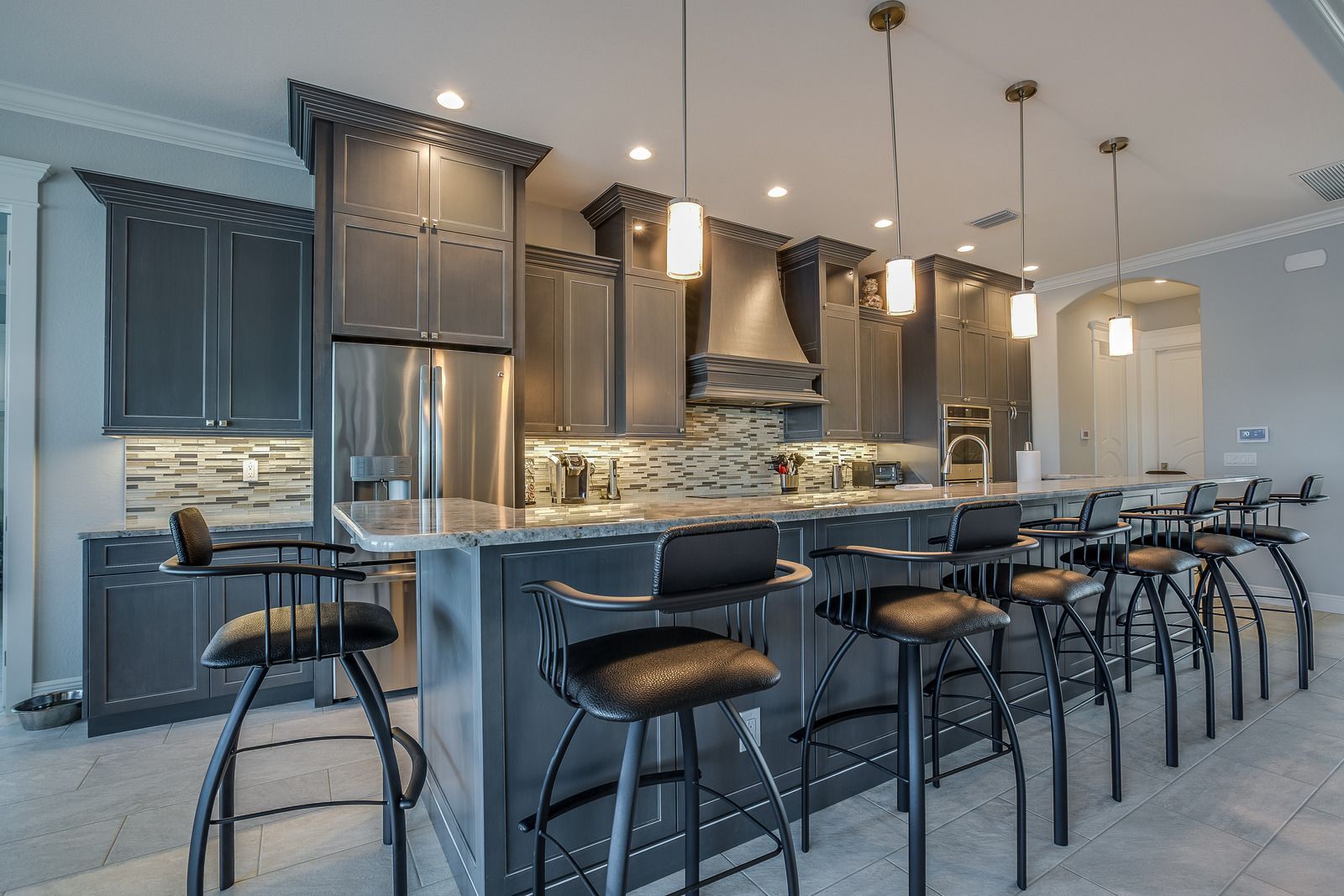 A kitchen with a large island and stools