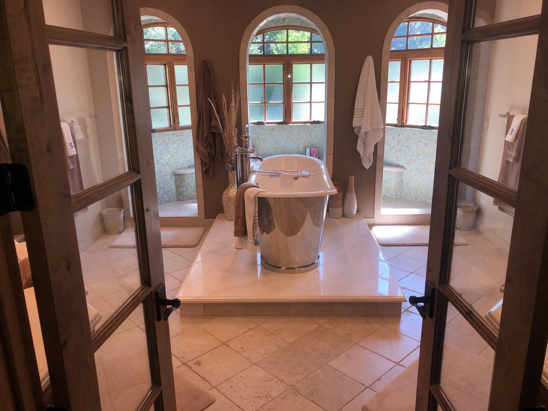 A bathroom with a bathtub in the middle of it