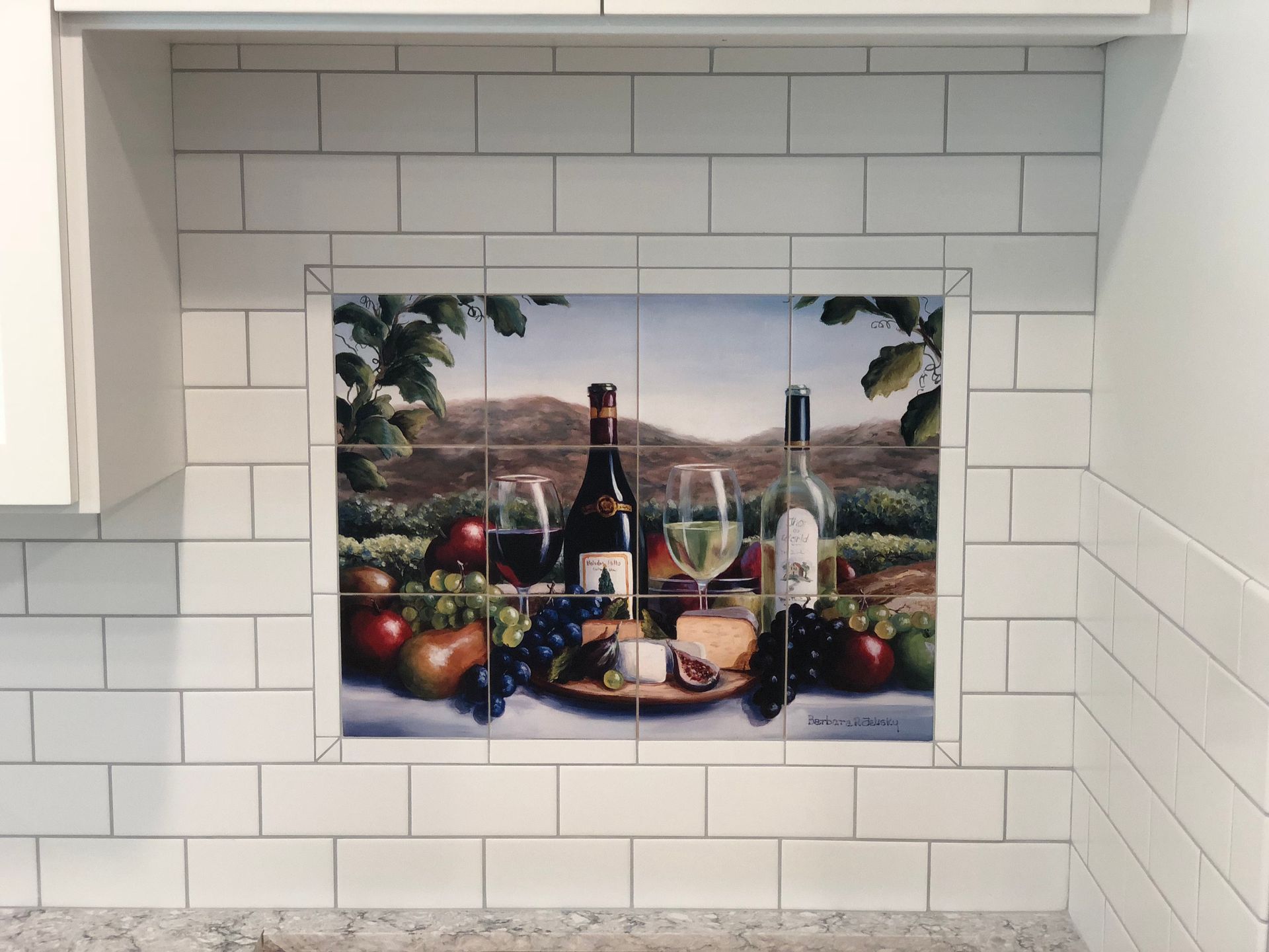 A painting of wine bottles and glasses on a white tile wall