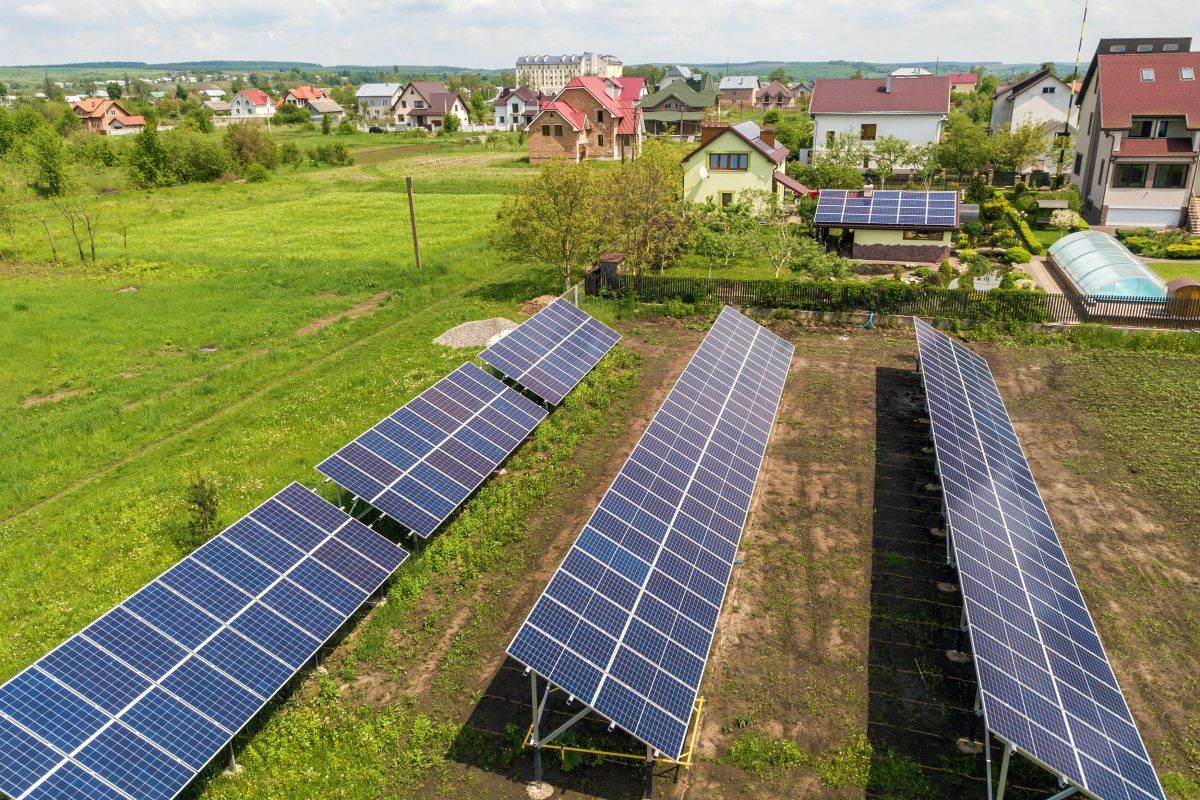 An aerial view of a row of solar panels in a field.