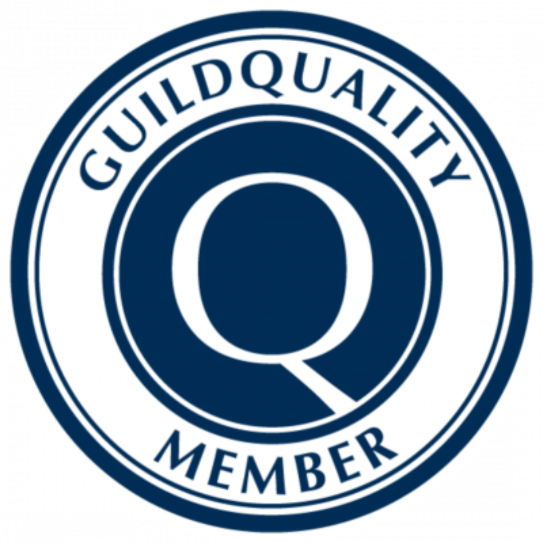 A guild quality member logo with a magnifying glass in the center