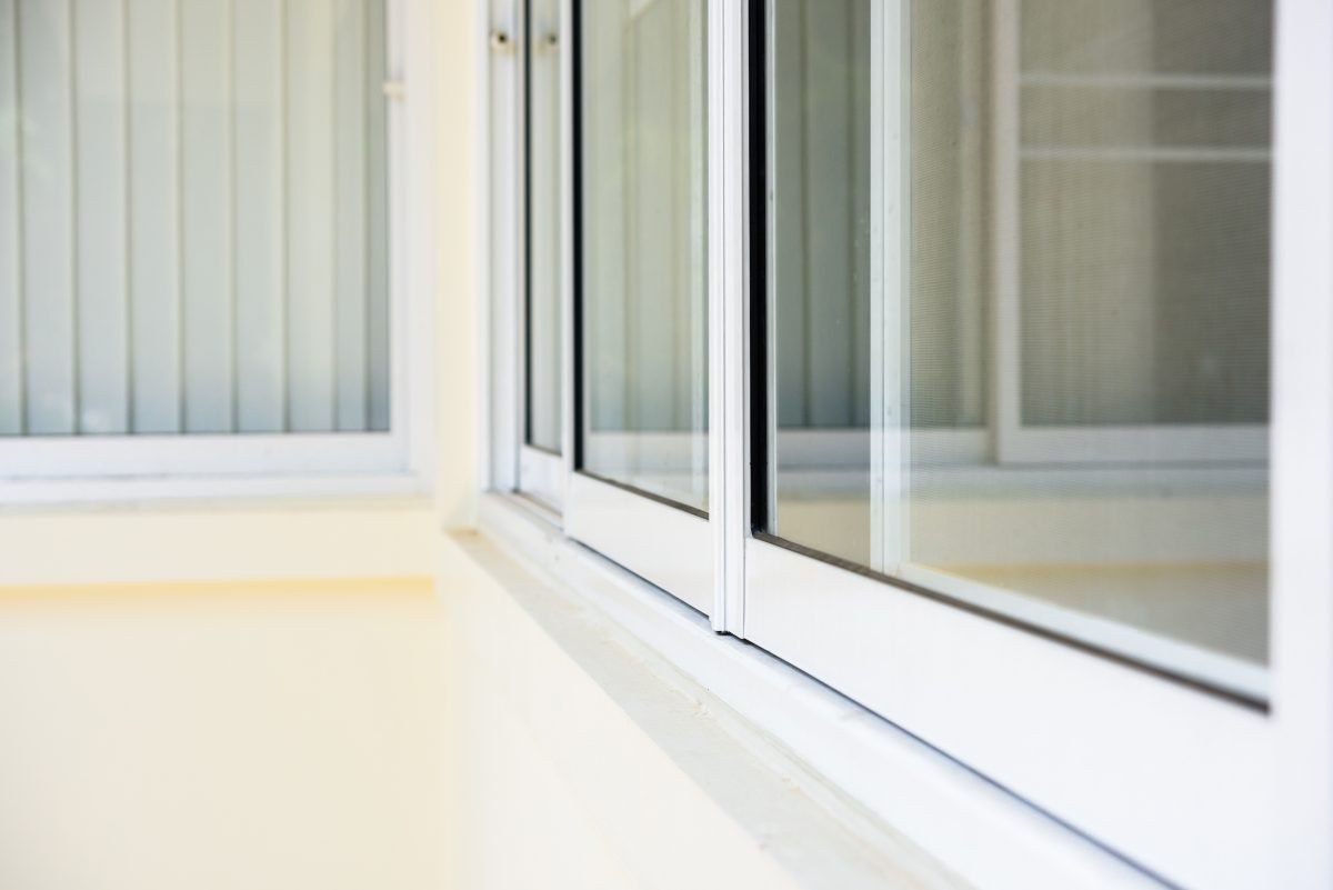 A close up of a white sliding glass door in a room.