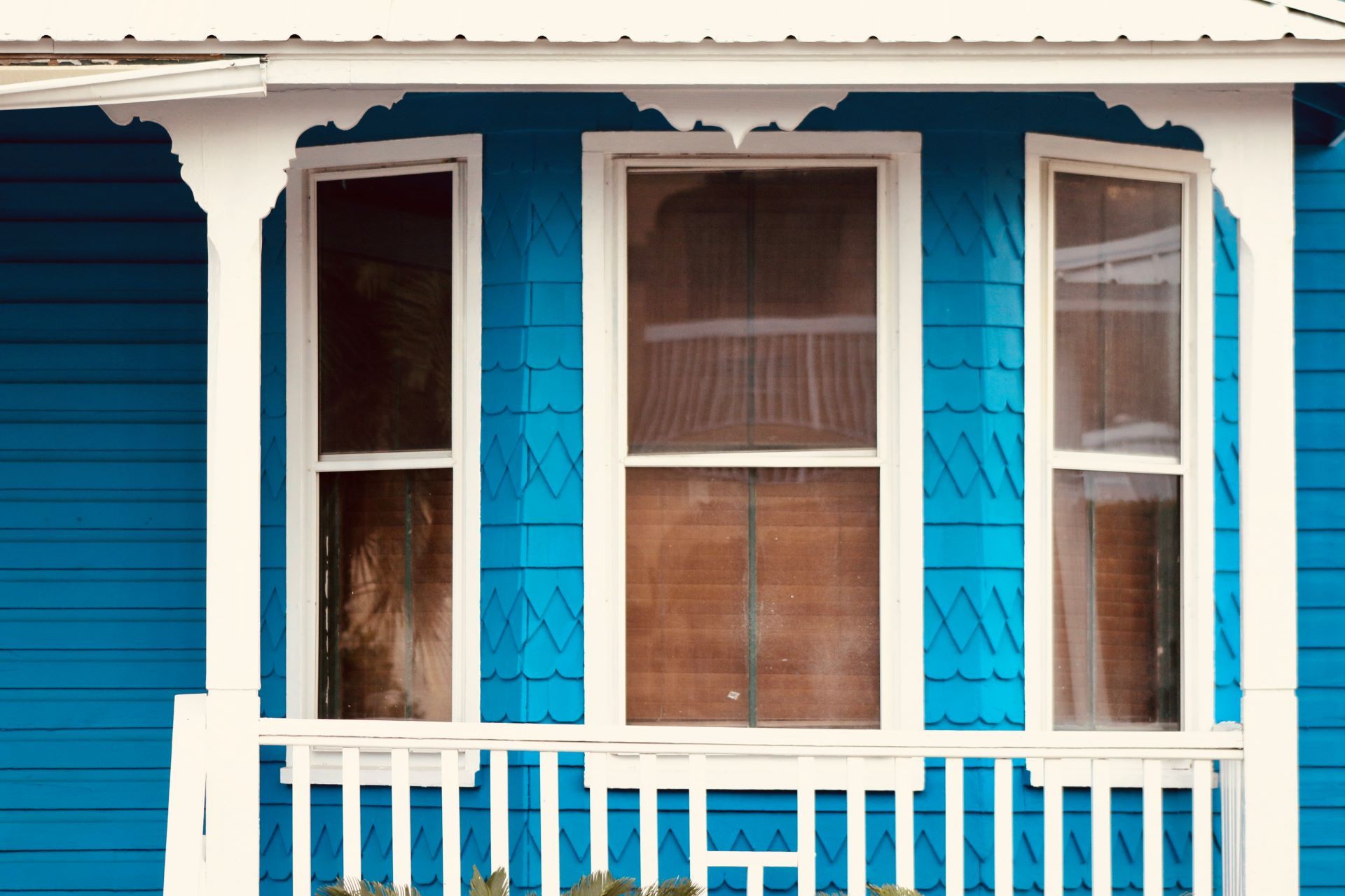 photo of front porch on a blue home with windows and white trim