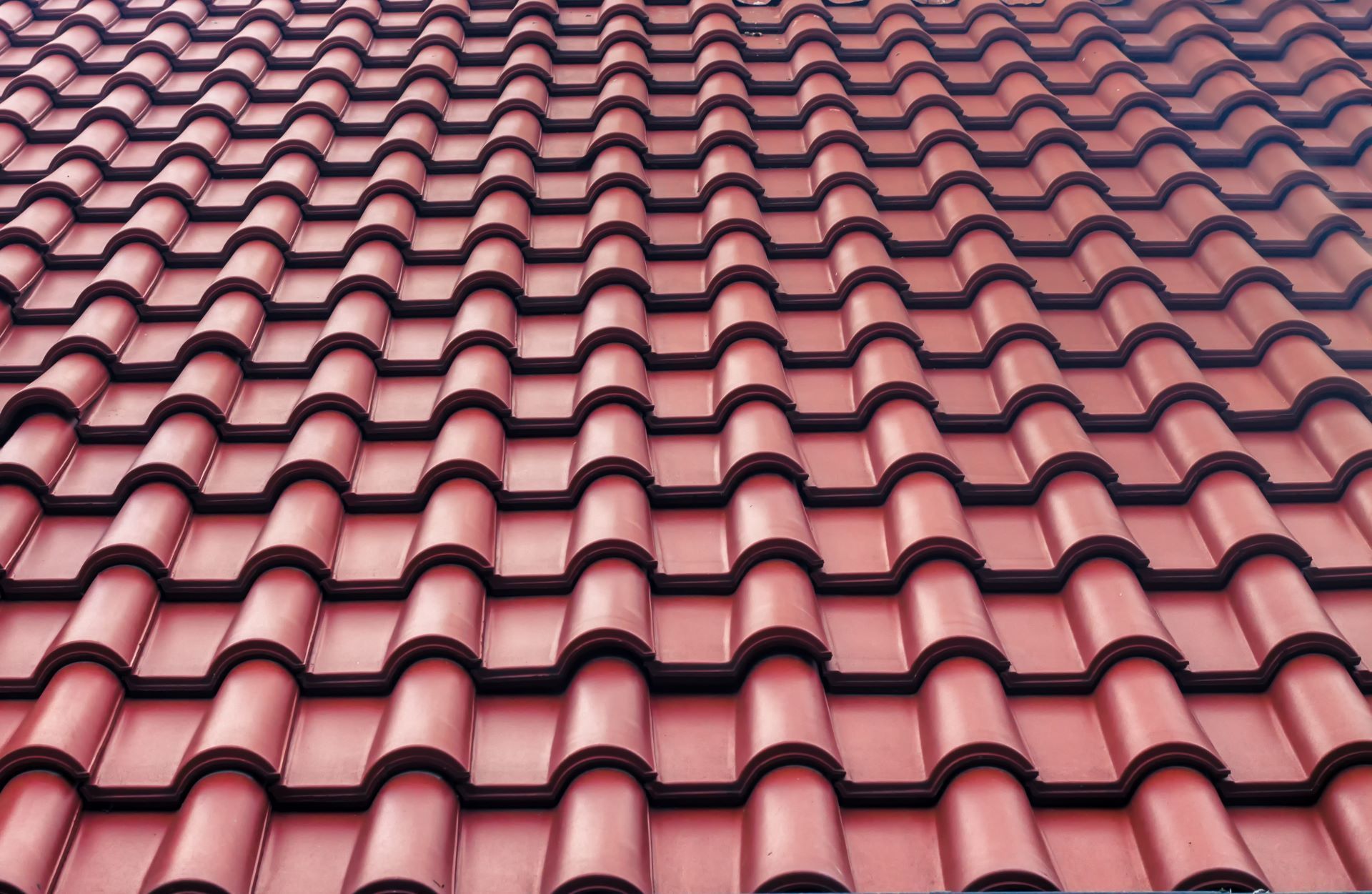 close up of red tiles on roof