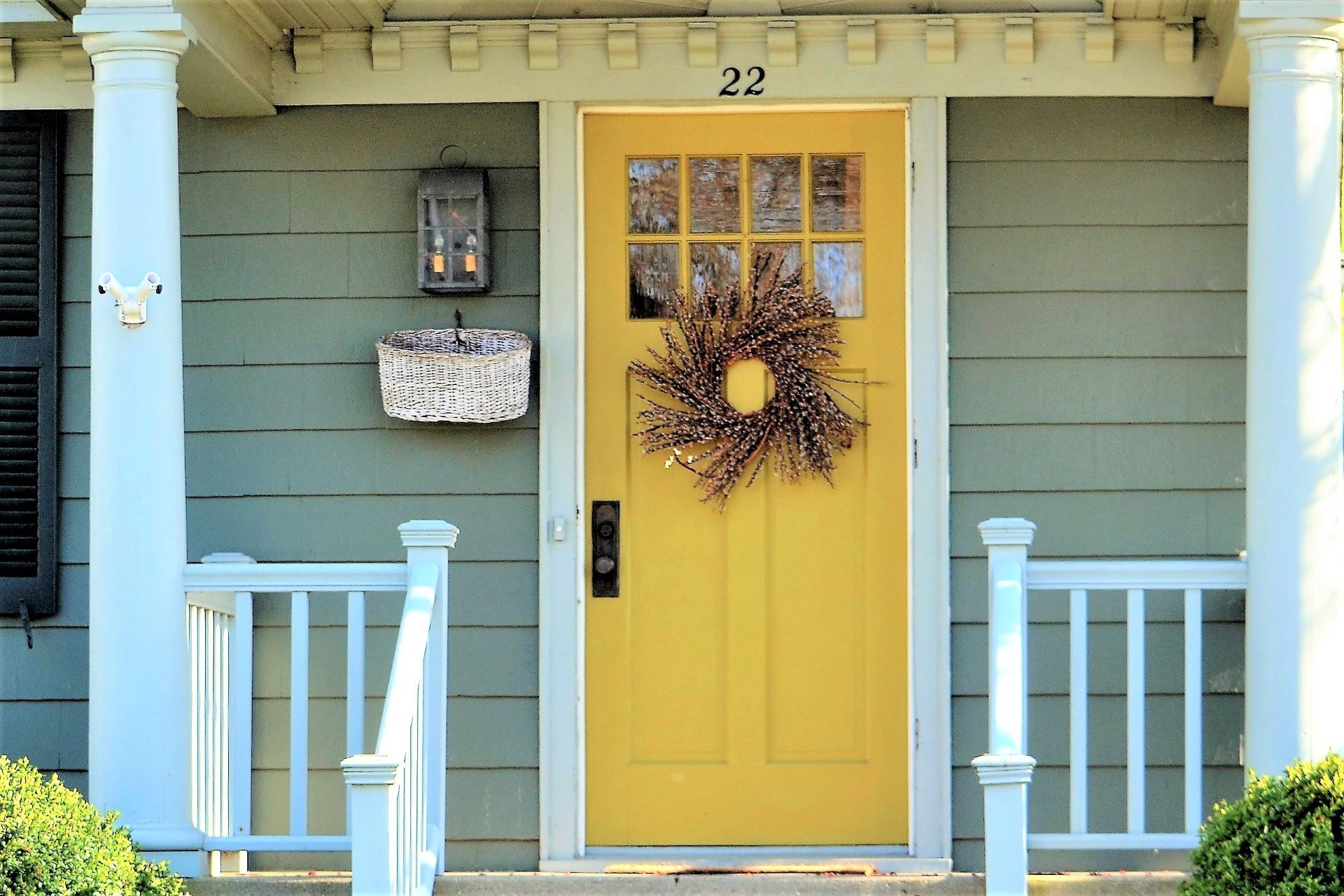 Yellow front door with decorative wreath