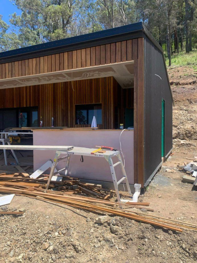 A House Is Being Built on Top of A Dirt Hill — Coastal Homes & Renovations in Crescent Head, NSW