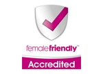 A female friendly accredited logo with a check mark on a shield.