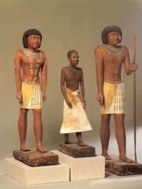 Three statues of men are standing next to each other on display.