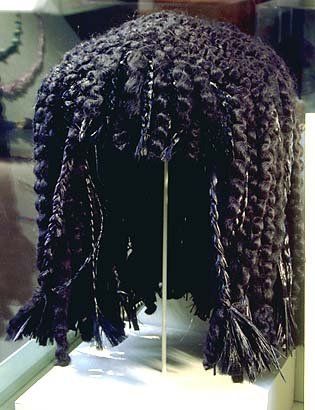A close up of a wig on display on a stand