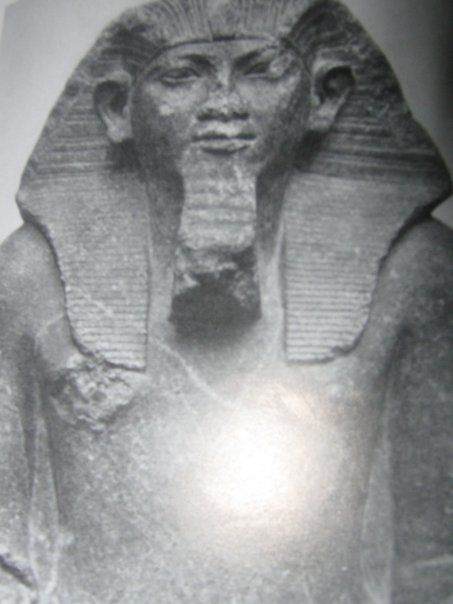 A black and white photo of a statue of a pharaoh