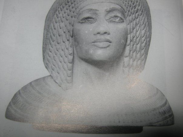 A black and white photo of a statue of a woman with long hair.