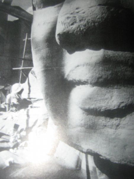 A black and white photo of a statue of a man 's face.