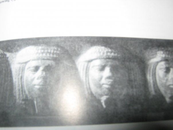 A black and white photo of three people wearing hats