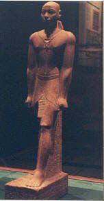 A statue of a man standing on a pedestal in a museum.