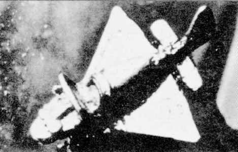 A black and white photo of a plane flying through the air.