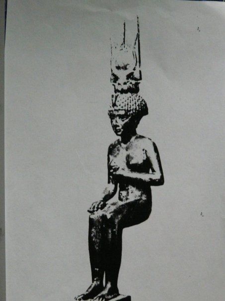 A black and white photo of a statue of a woman with a crown on her head