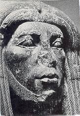 A black and white photo of a statue of a woman 's face.