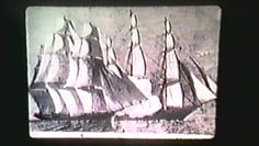 A black and white photo of a sailboat in the water.