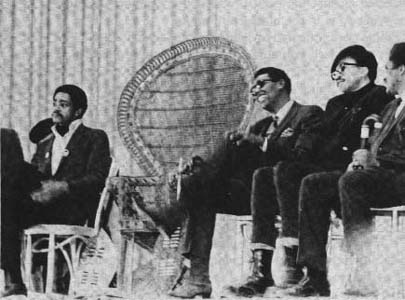 A group of men are sitting in chairs in a black and white photo.