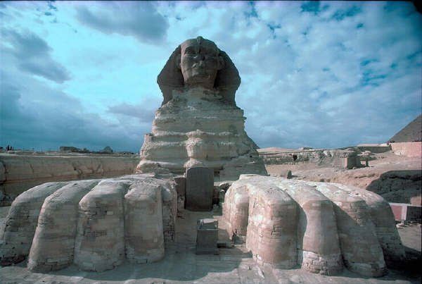A statue of a sphinx stands in the middle of a desert