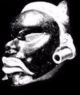 A black and white photo of a man 's face with headphones on.