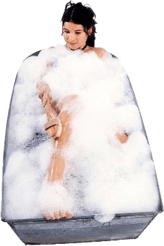 A woman is taking a bath in a tub filled with foam.