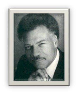 A black and white photo of a man with a mustache