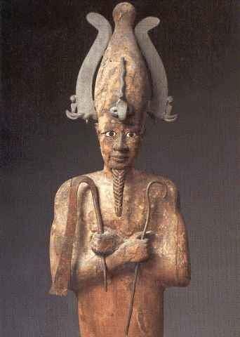 A statue of a man with a cane and a bird on his head.