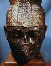 A close up of a statue of a man with a crown on his head.