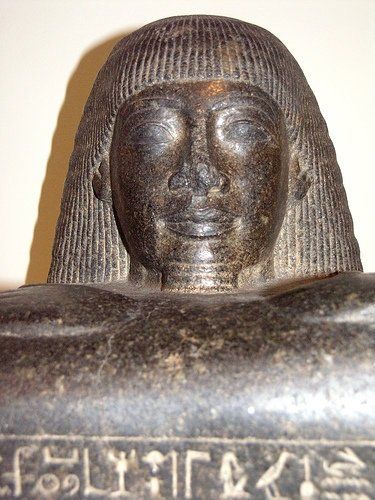 A close up of a statue of a woman with foreign writing on it