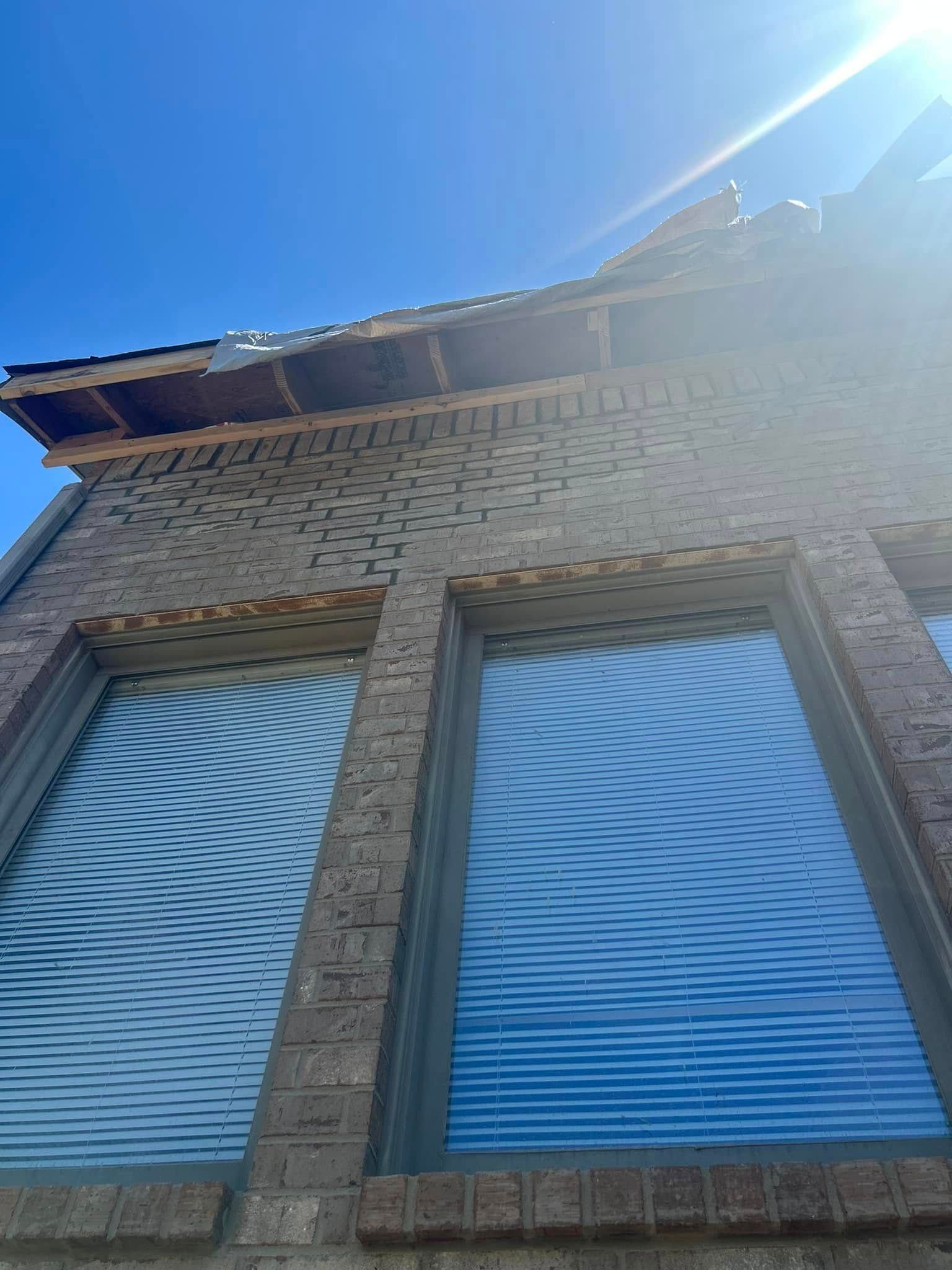 The sun is shining through the windows of a brick building.
