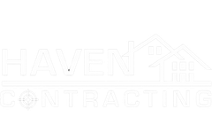 A white logo for a construction company with a house in the background.