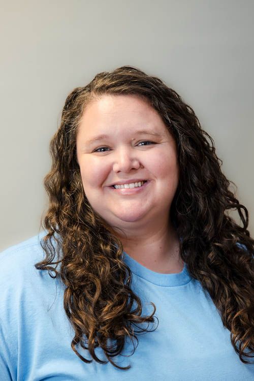 A group of people standing in front of a sign for sugar creek animal hospital