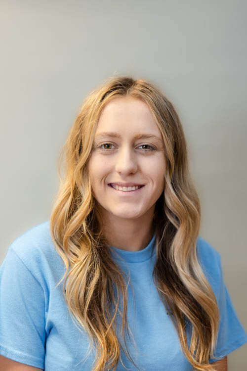 A group of people standing in front of a sign for sugar creek animal hospital