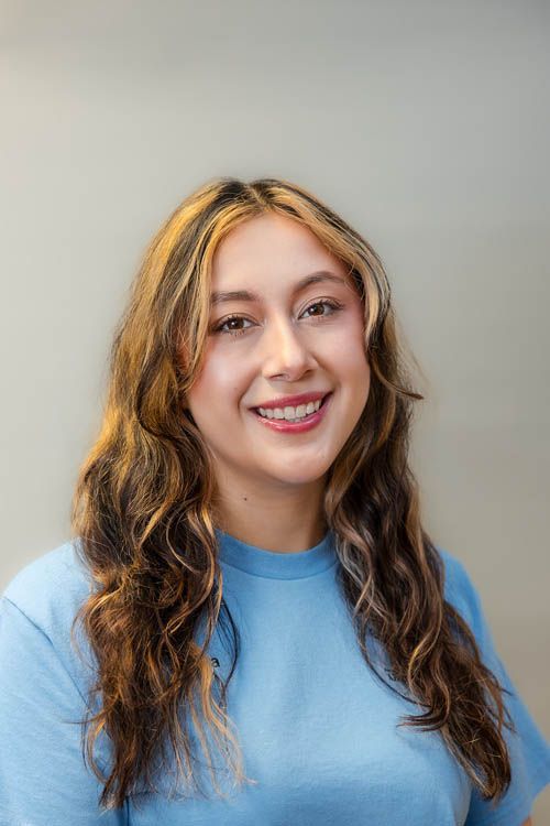 A group of people standing in front of a sign for sugar creek animal hospital