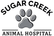 The logo for sugar creek animal hospital has a paw print on it.