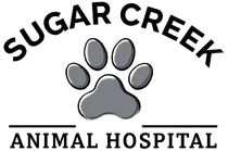 The logo for sugar creek animal hospital has a paw print on it.