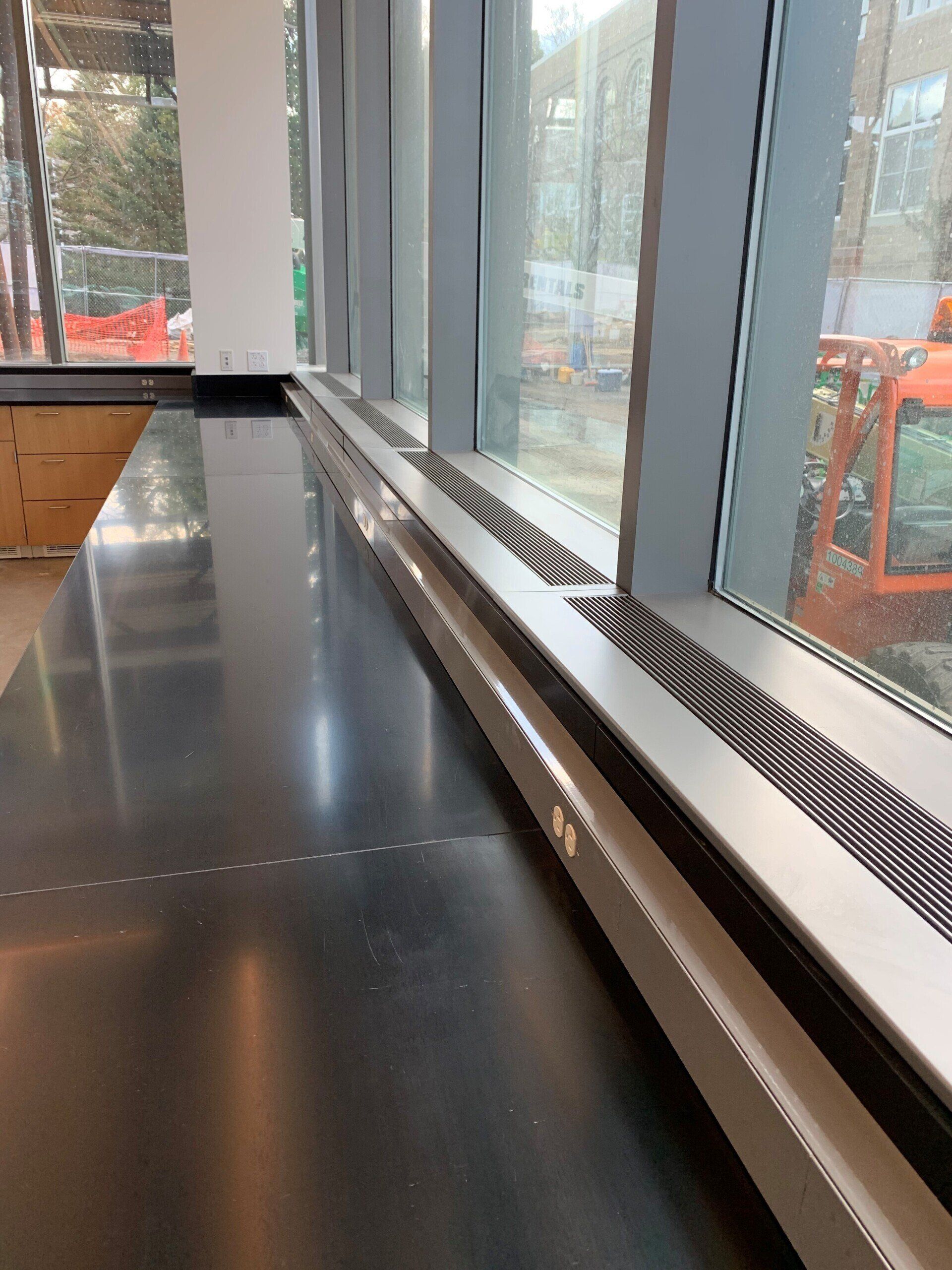 A large window with a black counter top in front of it