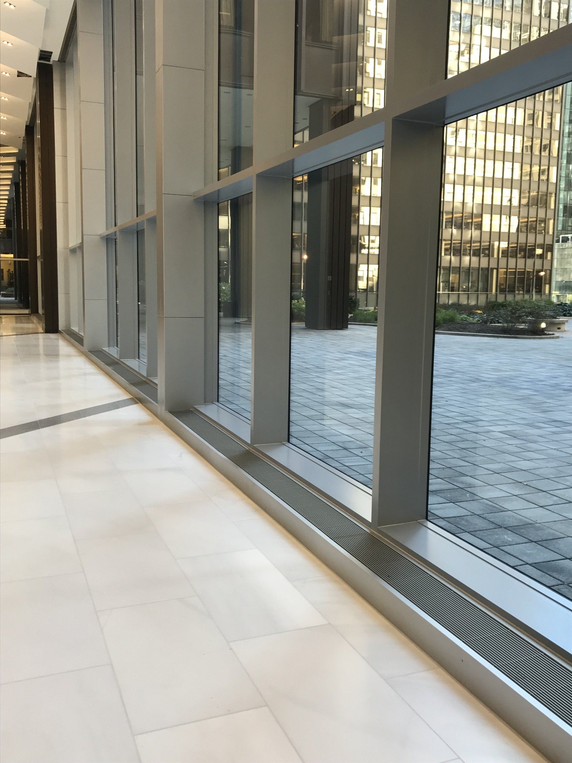 A hallway in a building with a lot of windows