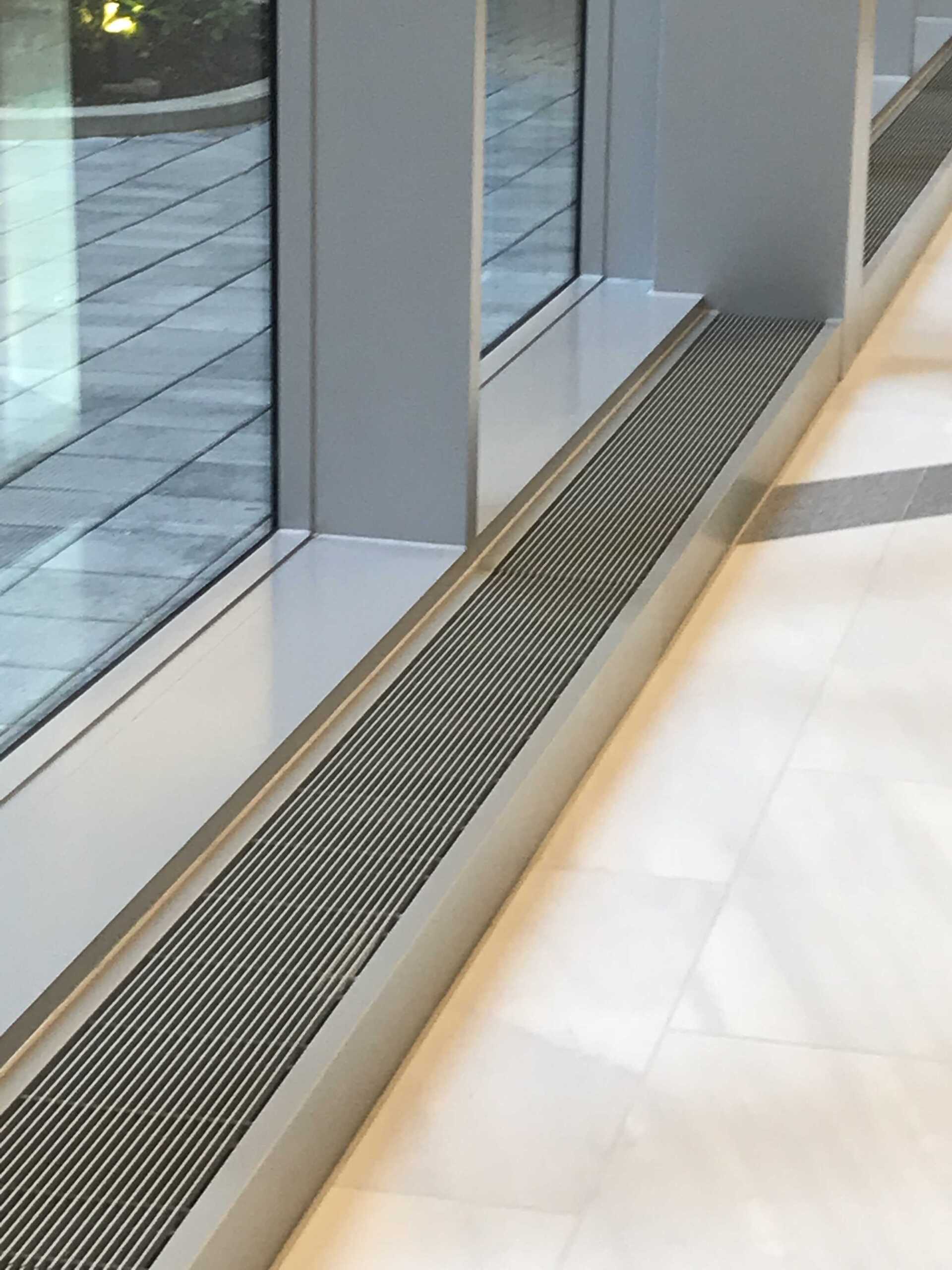 A window with a drain underneath it