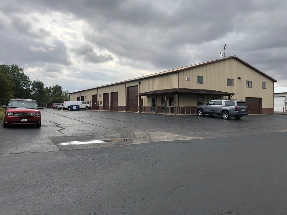 A large building with cars parked in front of it