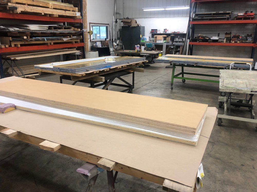 A large piece of cardboard is sitting on top of a table in a workshop.